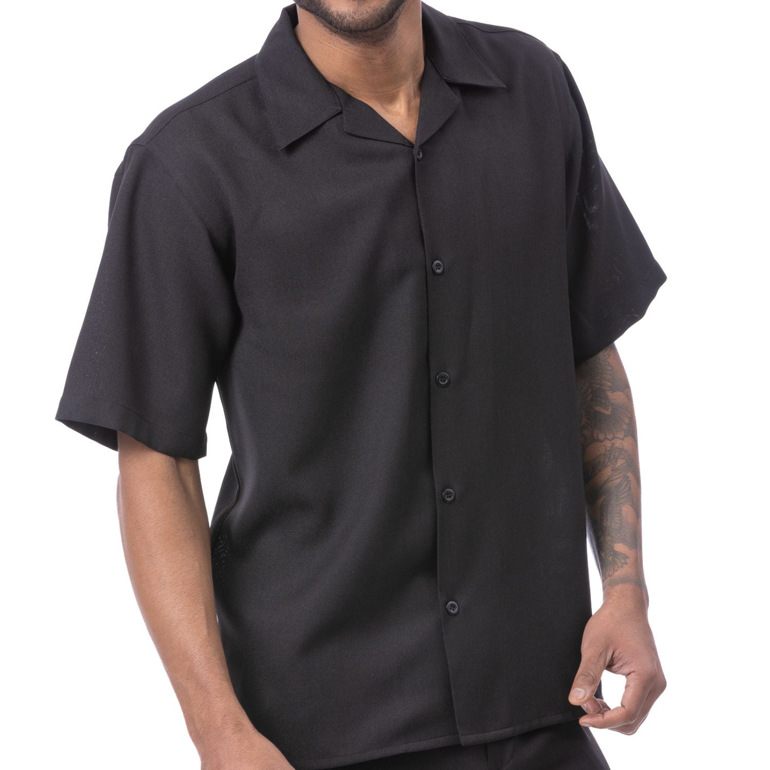 Front view of the black short sleeve walking suit shorts set on a model.
