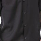 Close-up of black men's walking suit shirt showing the detailed linen-look texture 