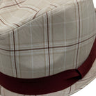 Close-up burgundy ribbon band detail on tan fedora