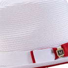 Close-up side profile of the Dazzluxe Collection white and red fedora showing the wide brim and pinch crown.