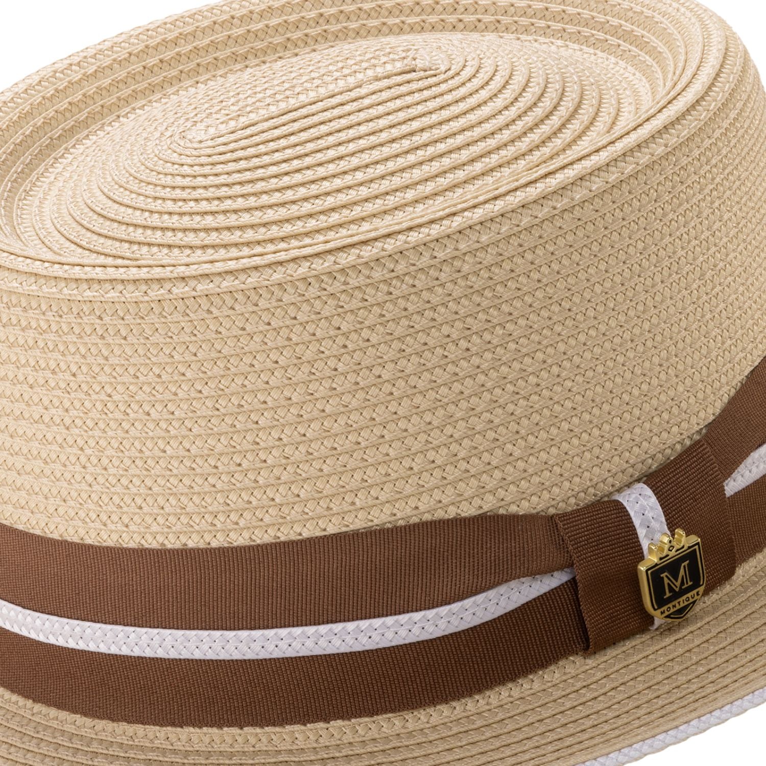 Close-up of the brown ribbon and white double stripe detail on a beige Montique pork pie hat.