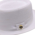 Close up of white Montique pork pie hat showing woven straw texture, matching band, bow detail, and logo pin