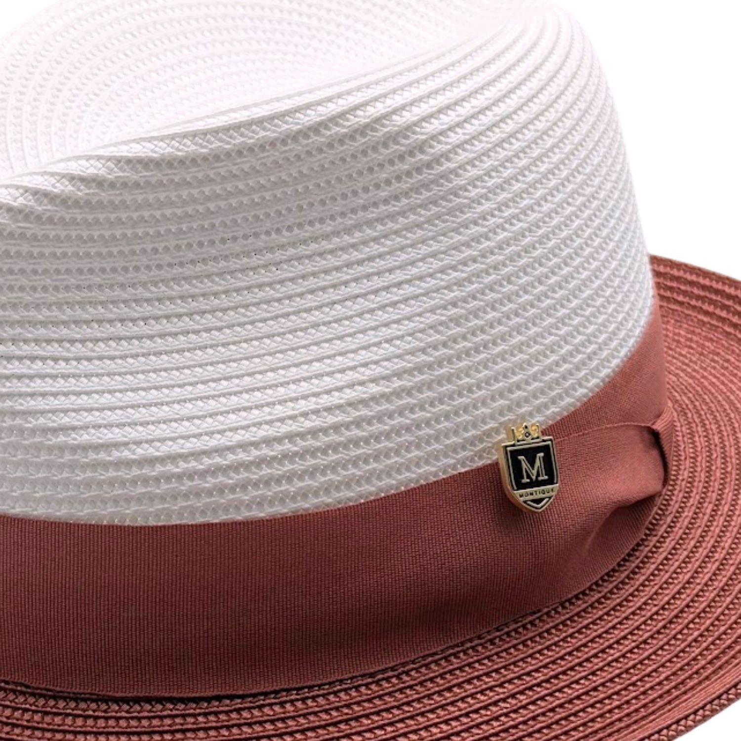 Close-up of white and cognac men’s fedora hat with woven crown, rust band, side bow, and Montique pin