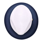 Navy and white Montique fedora hat top view showing white woven crown, navy wide brim, and structured straw-style texture