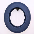 Navy and white Montique fedora hat interior view with navy woven brim, black sweatband, white crown, and branded label