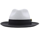 Black and white Montique fedora hat front view with white crown, black ribbon band, side bow, logo pin, and black brim
