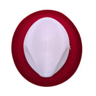Red and white Montique fedora hat interior view showing red woven brim, white crown, sweatband, and branded label