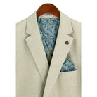 Close-up detail of light green textured weave blazer fabric and interior lining