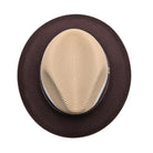 Beige and brown fedora hat top view showing beige crown, dark brown brim, white side trim, and woven texture