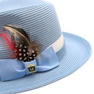 Montique Carolina blue straw fedora hat angled view with wide brim, feather detail, light blue bow, and white band