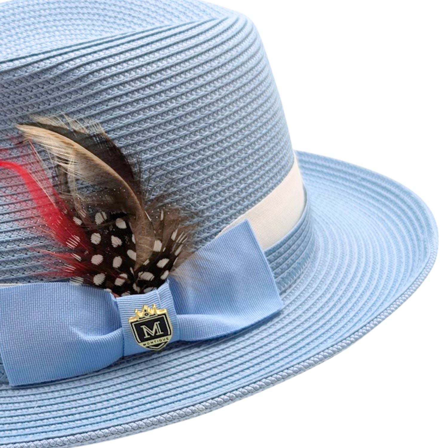 Montique Carolina blue straw fedora hat angled view with wide brim, feather detail, light blue bow, and white band