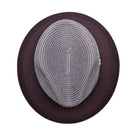 Wine and white Montique fedora hat top view showing woven crown, solid wine brim, and side logo pin detail