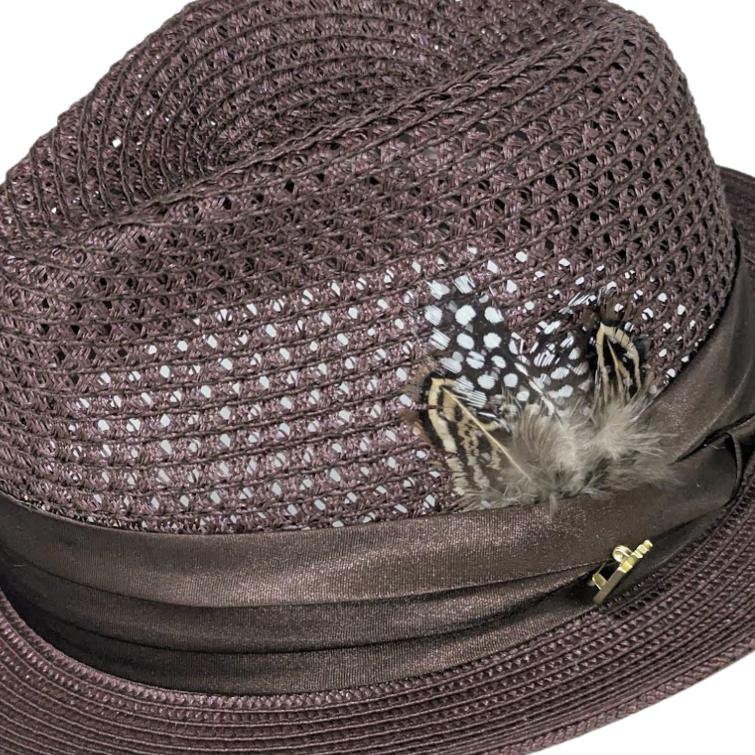 Brown Montique fedora hat close-up with open weave crown, satin ribbon band, feather accent, and logo pin