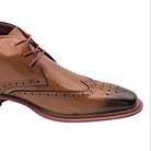 tan wingtip lace boot with burnished toe and brogue detailing side view close-up