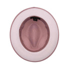 Blush and white Montique fedora hat interior view with blush crown, white brim underside, blush edge trim, and branded sweatband
