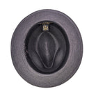 Inside view of black men’s fedora hat showing woven straw texture, black sweatband, and Montique label