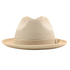 Beige Montique fedora hat front view with matching ribbon band, white bow accent, woven crown, and Montique logo pin