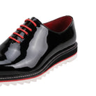 close up of black patent plain toe lace-up leather dress shoes