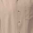 Close-up of khaki solid walking suit shirt showing the open collar and clean button-front design.