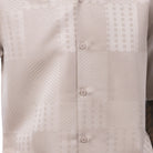Close-up of the beige shirt showing the detailed tonal jacquard panel weave and textured pattern.