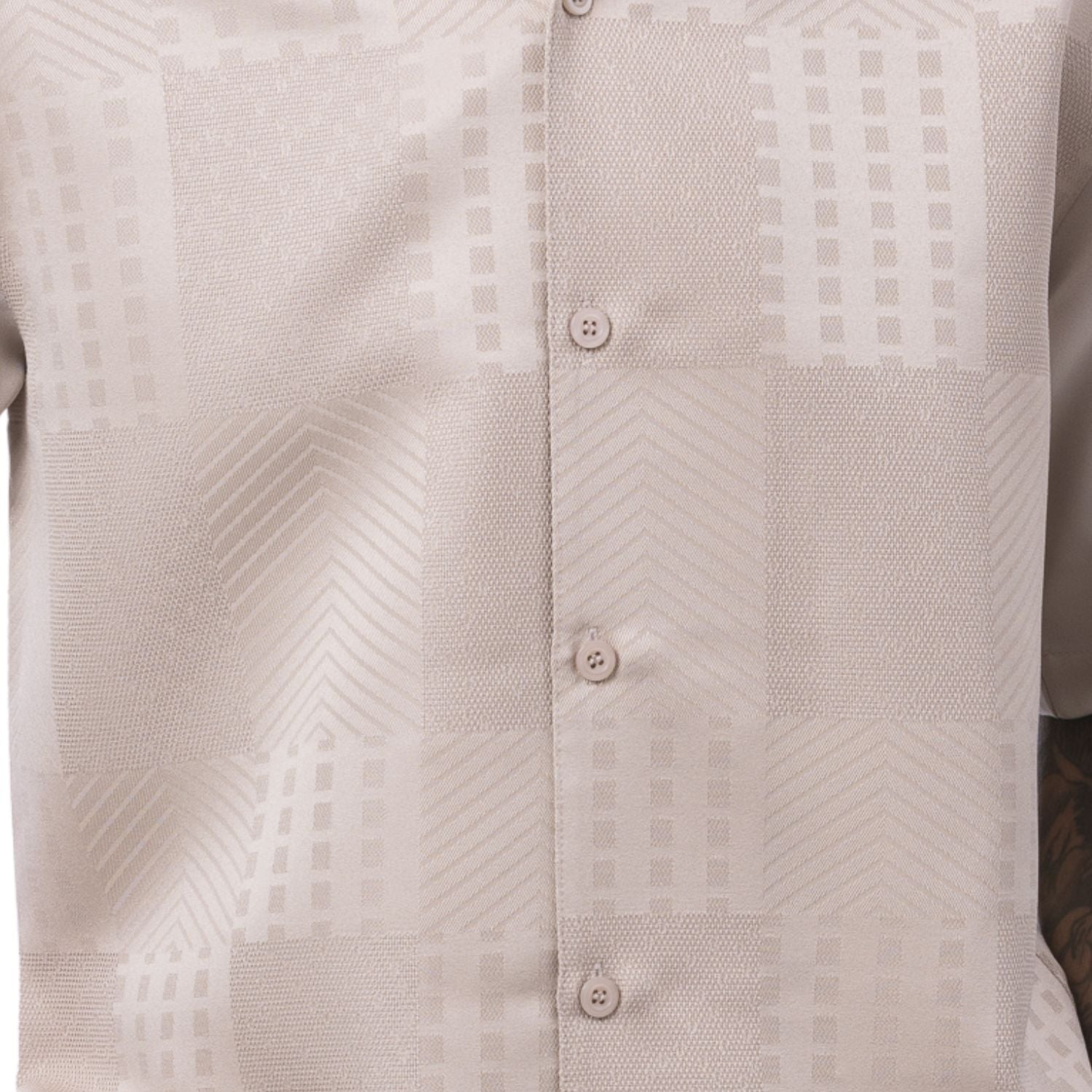 Close-up of the beige shirt showing the detailed tonal jacquard panel weave and textured pattern.