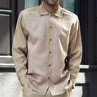 Close-up of the tan Montique 2684 shirt showing its tone-on-tone pattern, rounded collar and button front