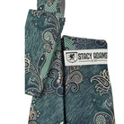 Close-up of the layered teal, mint, and soft sand "Cipher" paisley pattern from the Stacy Adams collection.