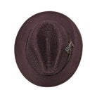 Brown Montique fedora hat top view showing open weave crown, wide brim, and side feather accent