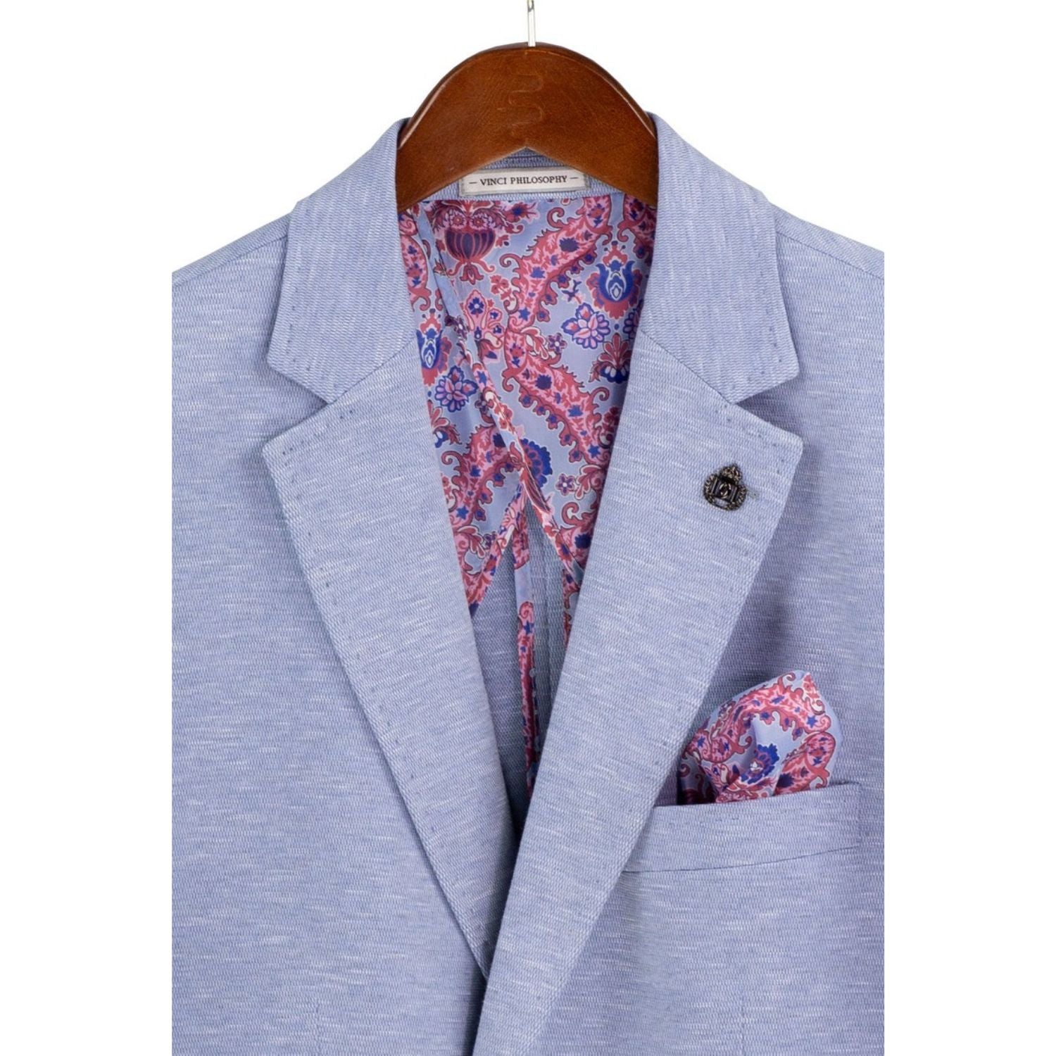 Close-up detail of light blue textured weave blazer fabric and lapel stitching