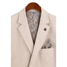 Close-up detail of oatmeal textured weave blazer fabric and lapel stitching