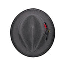 Black Montique fedora hat top view showing pinched crown, woven brim, black bow, and red feather detail