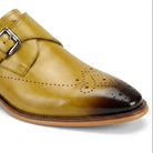 close up view of scotch leather monk strap shoes with brogue medallion toe