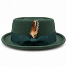 Hunter green pork pie wool felt hat by Montique side view with grosgrain bow and multicolor feather accent