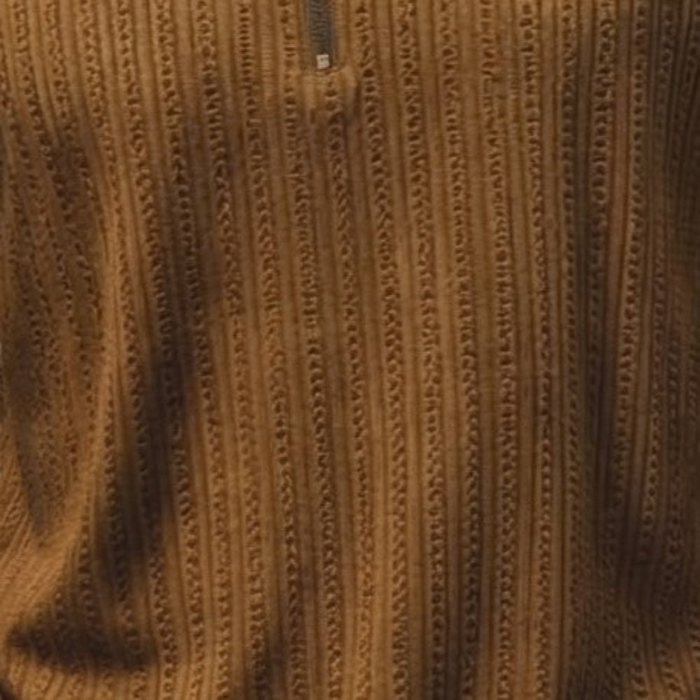 close-up of the tan studded knit polo 