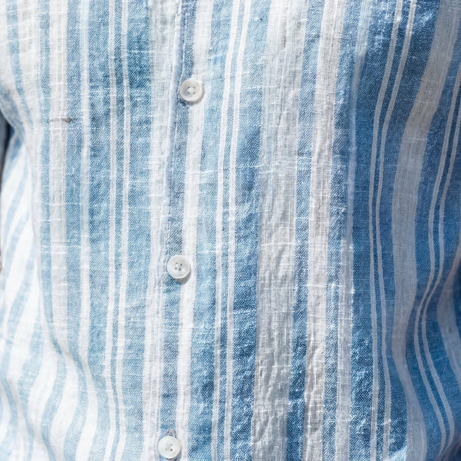 Close-up fabric of blue striped seersucker short sleeve shirt 