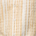 Close-up fabric of tan striped seersucker short sleeve shirt 
