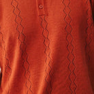 persimmon red short sleeve woven knit polo with vertical textured pattern fabric details