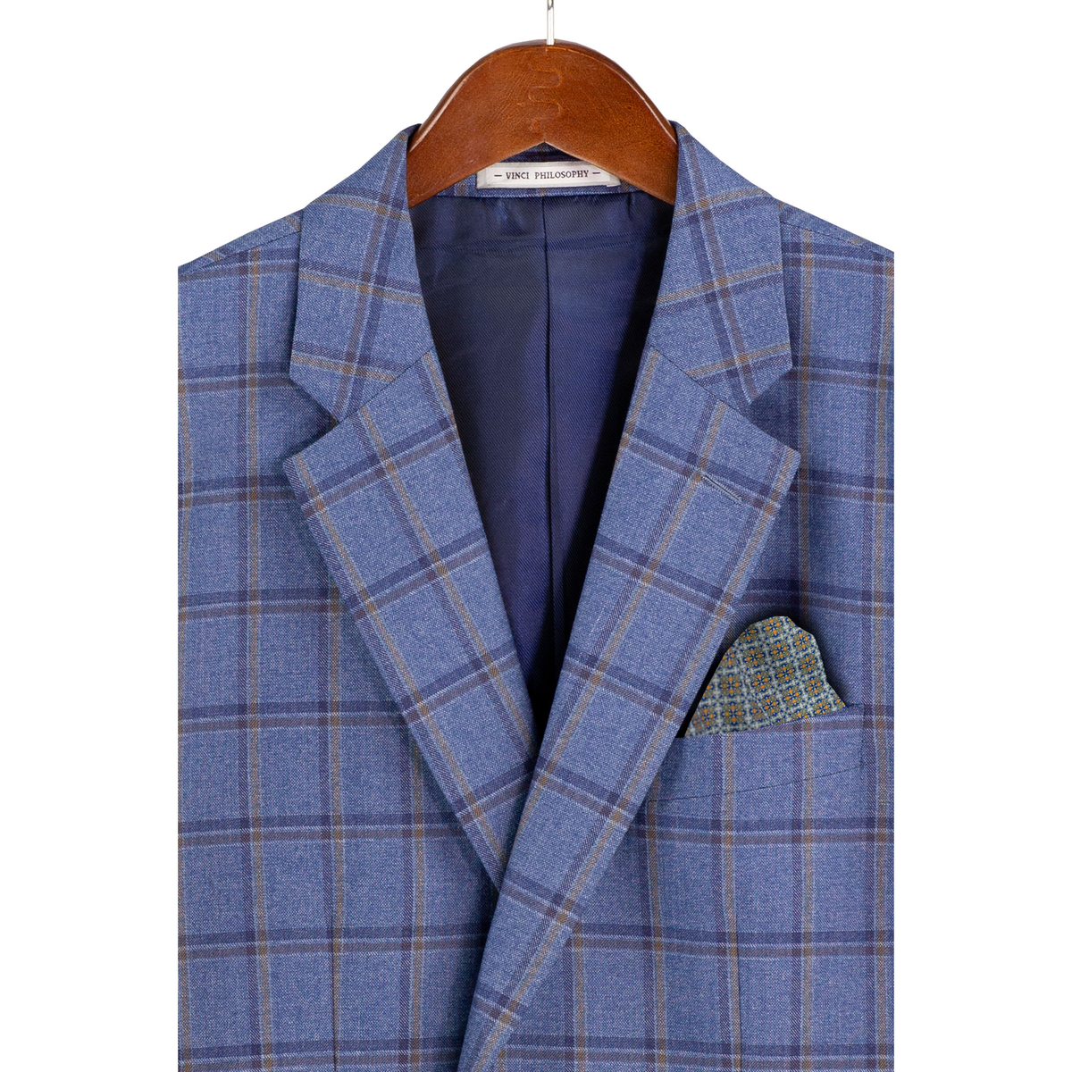Close-up of the blue windowpane plaid jacket on a hanger, showing notch lapels, chest pocket and lining.