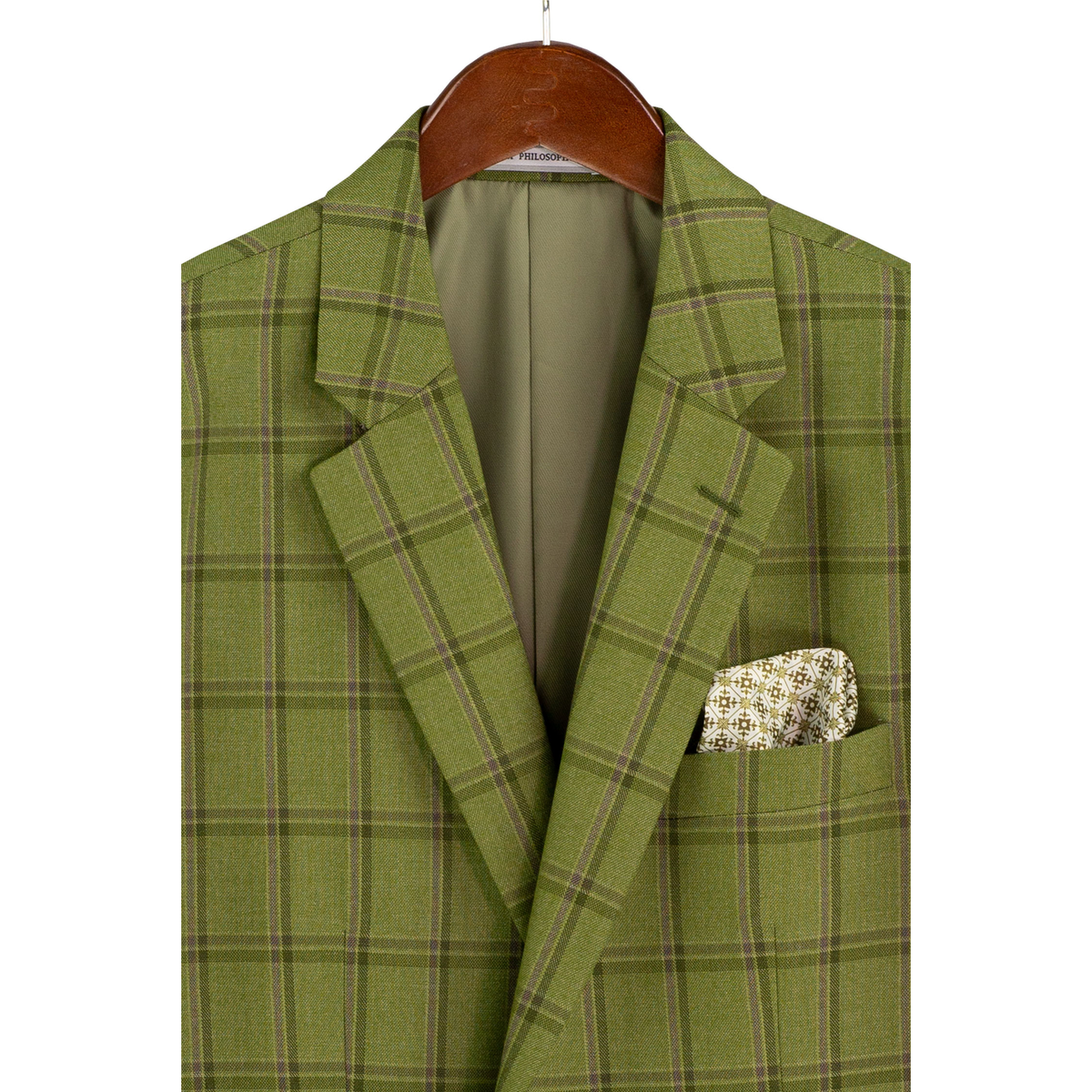 Close-up of the moss green plaid jacket on a hanger, showing notch lapels, chest pocket and lining.