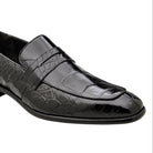 Angled view of black alligator penny loafer