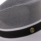 Close up of white wide brim straw fedora hat pinch crown