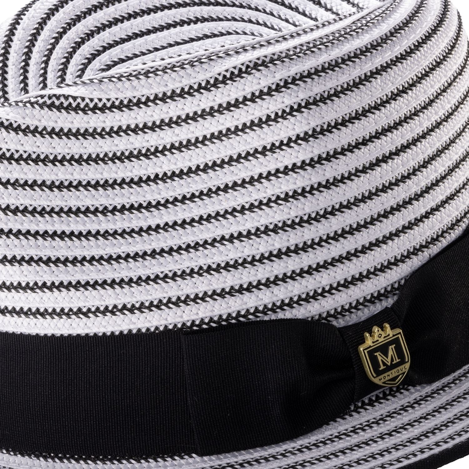 Close-up of the black striped fabric texture and the signature Montique metal pin on the ribbon band.