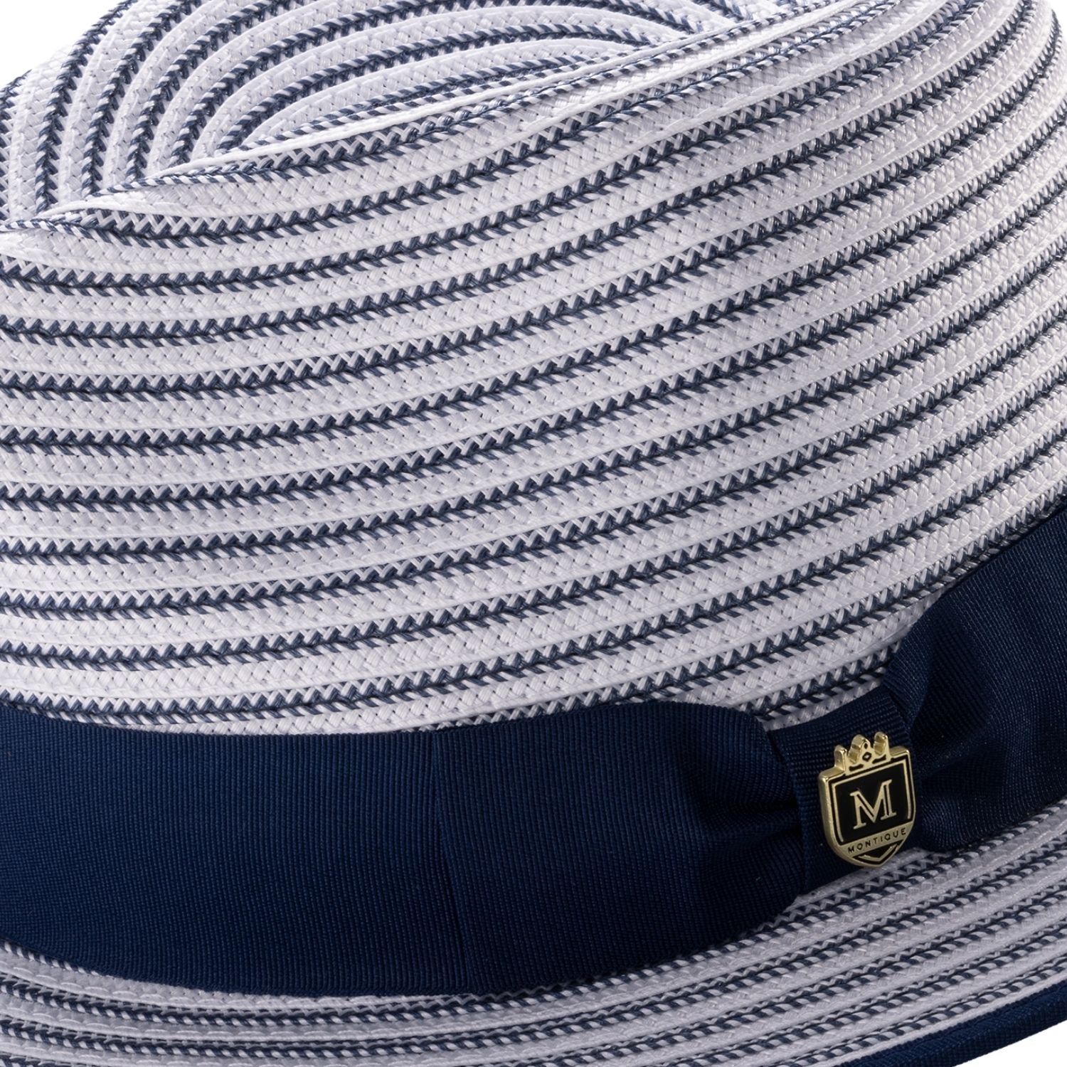Close-up of the navy striped fabric texture and the signature Montique metal pin on the ribbon band.