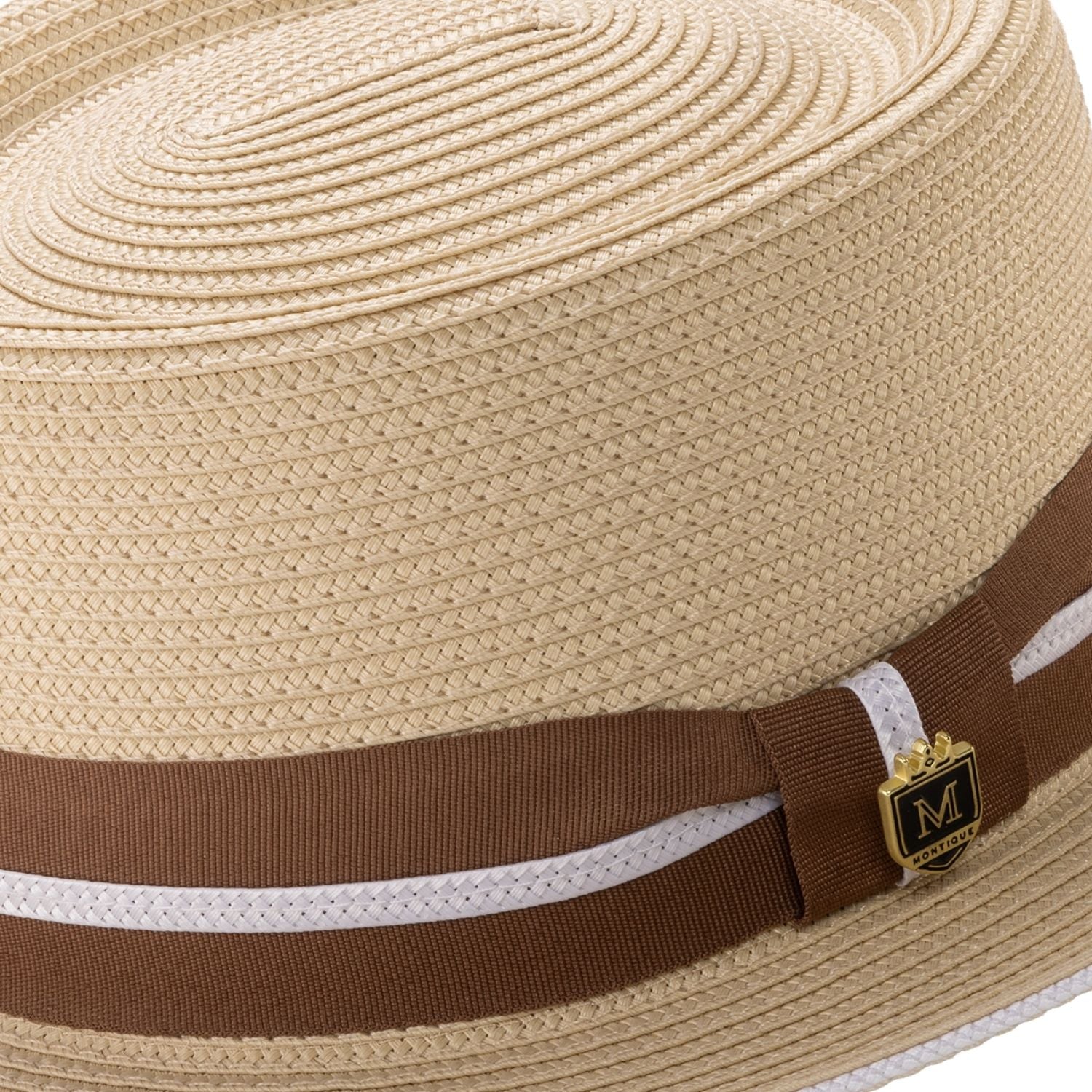 Close-up of the brown ribbon and white double stripe detail on a beige Montique pork pie hat.