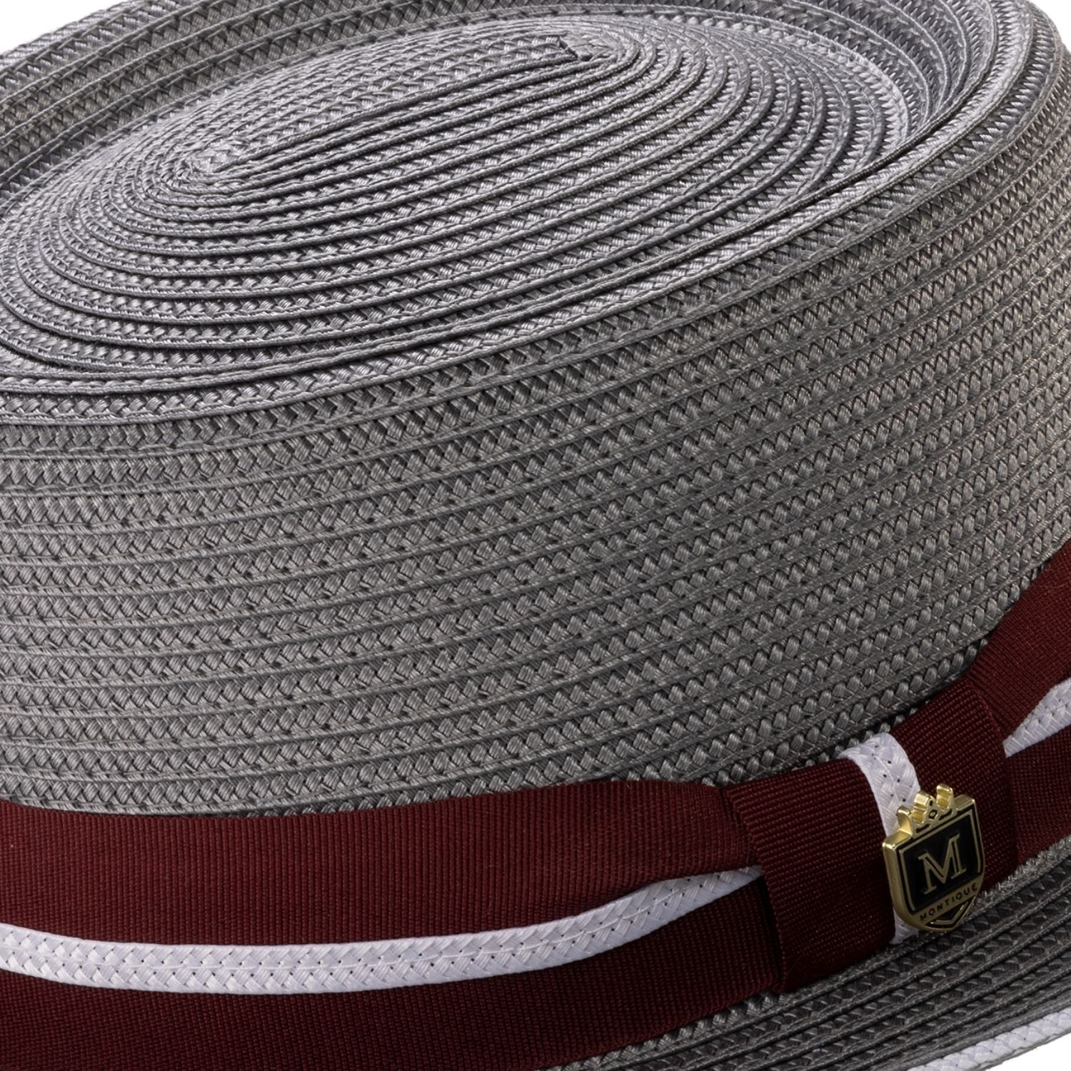 Close-up of the burgundy ribbon and pink double stripe detail on a grey Montique pork pie hat.