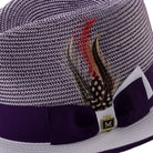 Side view of purple and white Montique fedora hat with ribbon and feather