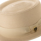 Close-up beige hat band and crest pin