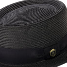 Close-up black hat band and crest pin