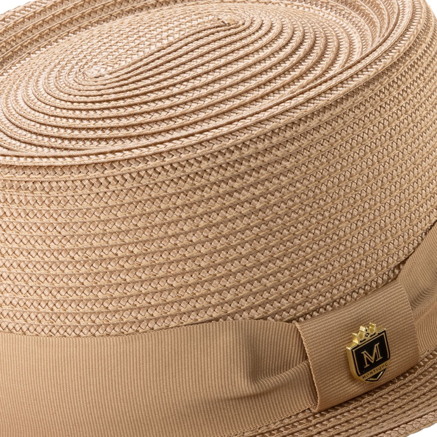 Close-up camel hat band and crest pin