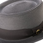 Close-up grey hat band and crest pin